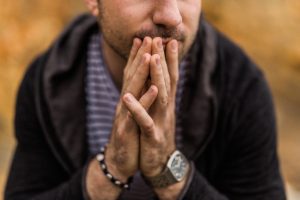 Man in a thinking pose.