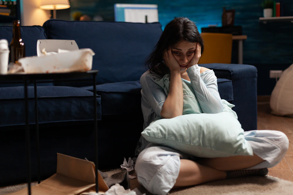 Woman on the floor battling through a bout of depression